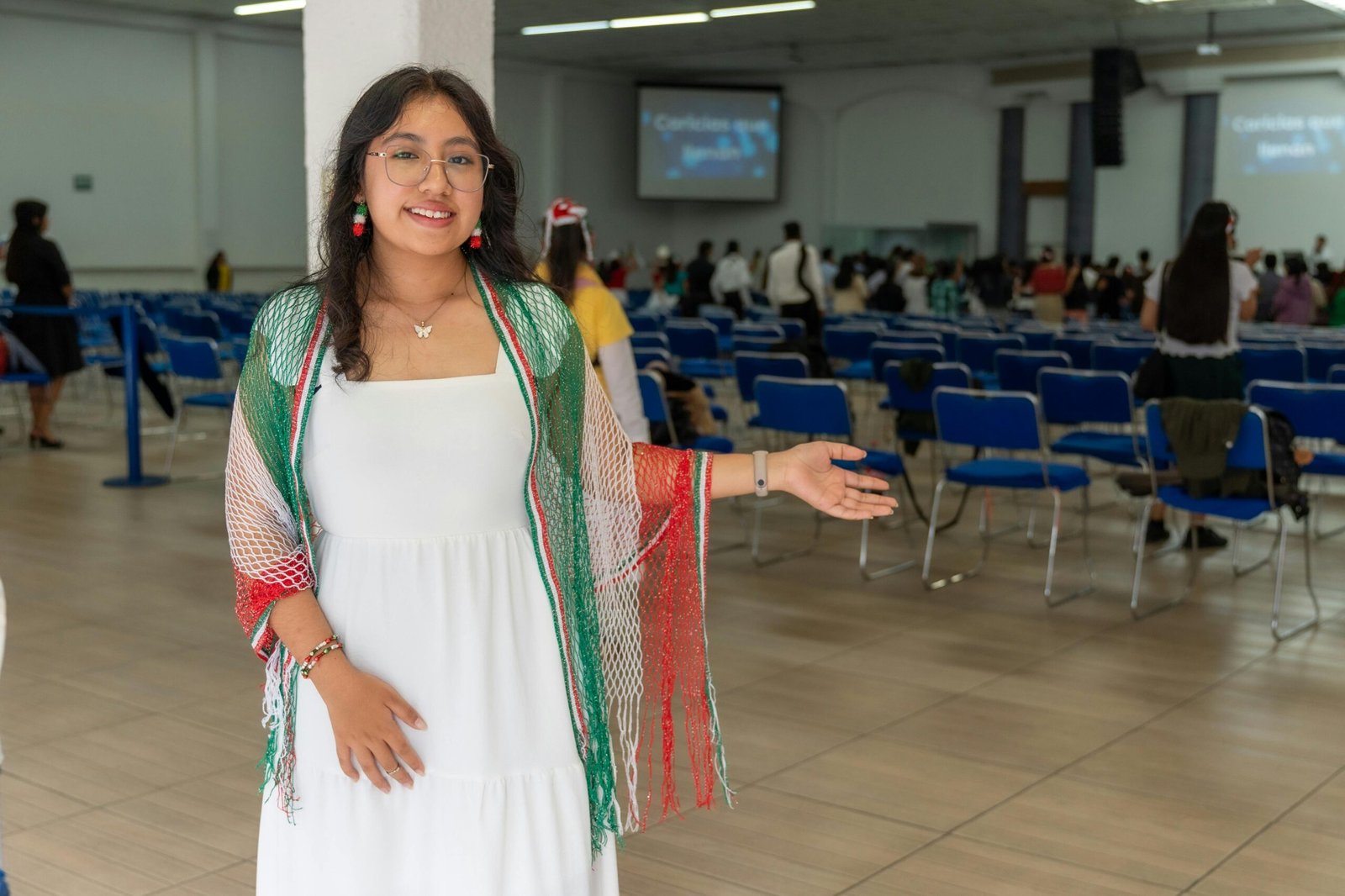 A woman in traditional Mexican attire poses inside a church in Ciudad de México.